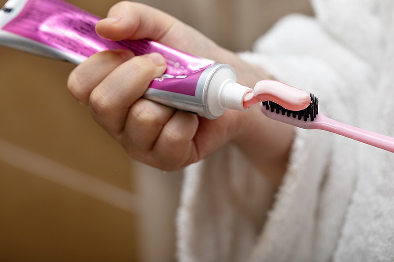 Close-Up of Child Putting Toothpaste on a Toothbrush