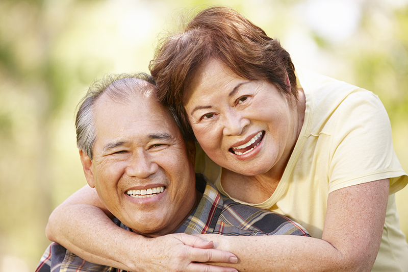 Older couple wearing affordable dentures